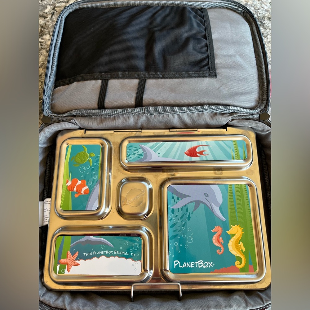 Planetbox rover style stainless steel lunch box with red carrying case.